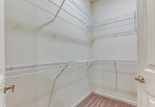 Walk-in closet with wire shelving system at High Point Preserve Apartments, Austin, 78724