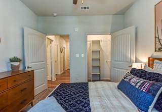 Bedroom with dual closets and hardwood flooring 1 at High Point Preserve Apartments, Austin