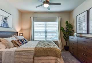 Bedroom with ceiling fan and window blinds at High Point Preserve Apartments, Texas, 78724