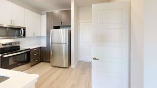 A kitchen with a refrigerator, oven, and microwave. at Bridge at Speyside Apartments, Austin