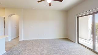 A room with a ceiling fan and a carpeted floor. at Bridge at Speyside Apartments, Austin, 78754