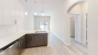 a kitchen with wooden cabinets and a white counter top at Bridge at Speyside Apartments, Austin, TX, 78754