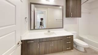 a bathroom with a mirror and a toilet and a sink at Bridge at Speyside Apartments, Austin