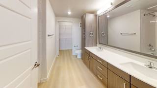 A bathroom with a white sink and a mirror.