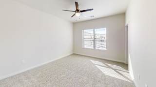 A room with a ceiling fan and a window with blinds. at Bridge at Speyside Apartments, Austin