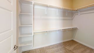 A white closet with shelves and a door. at Bridge at Speyside Apartments, Austin, 78754