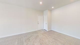 A room with a carpeted floor and a white door. at Bridge at Speyside Apartments, Texas, 78754