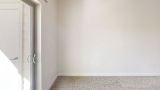 A room with a carpeted floor and a white door. at Bridge at Speyside Apartments, Austin, TX, 78754