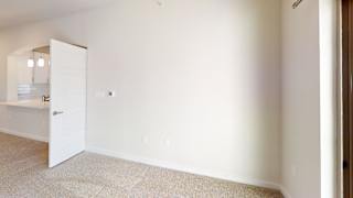 A white door is open to a kitchen. at Bridge at Speyside Apartments, Austin, TX, 78754