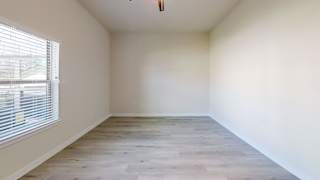 an empty room with white walls and a window at Bridge at Speyside Apartments, Austin
