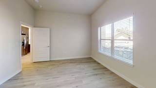 a living room with a large window and wood floors at Bridge at Speyside Apartments, Austin, Texas