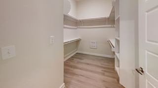 an empty room with white walls and wood flooring and a stairwell at Bridge at Speyside Apartments, Texas