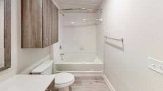 Bathroom with soaking tub and overhead storage at Bridge at Windsor Park Apartments, Texas, 78723