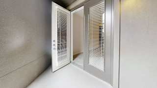 Entry door with white frame and integrated blinds at Bridge at Windsor Park Apartments, Austin, TX
