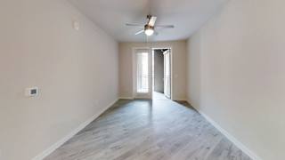 Empty room with ceiling fan and open doorway at Bridge at Windsor Park Apartments, Texas, 78723