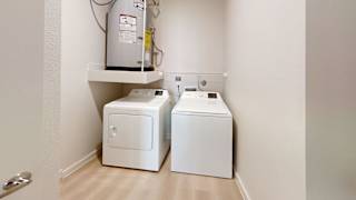 Two white toilets are sitting on a white shelf in a bathroom.