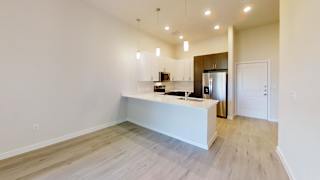 a kitchen with white cabinets and a white counter top at Bridge at Speyside Apartments, Texas