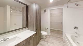 Bathroom with walk in shower and linen closet at Bridge at Windsor Park Apartments, Austin, TX