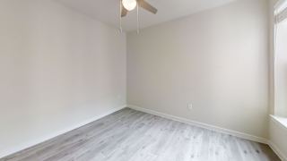 Empty bedroom with ceiling fan and gray flooring at Bridge at Windsor Park Apartments, Austin, Texas