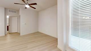 A room with a ceiling fan and a door.