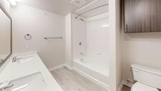 a bathroom with a tub and a sink and a toilet at Bridge at Speyside Apartments, Austin, Texas