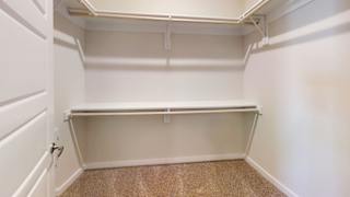 an empty closet in a home with white walls and a shelf at Bridge at Speyside Apartments, Texas, 78754