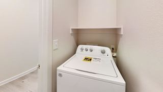 the laundry room is equipped with a washer and dryer at Bridge at Speyside Apartments, Austin