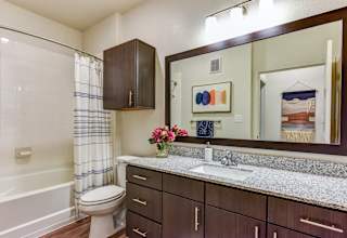 Bathroom vanity with granite countertop and wood cabinetry 1 at High Point Preserve Apartments, Texas, 78724