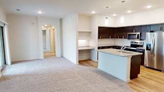 Open concept living room and kitchen with island 1 at High Point Preserve Apartments, Austin, TX 78724
