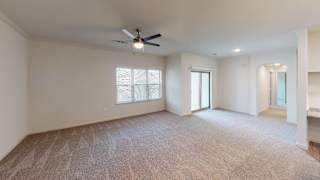 Spacious living room with carpet and ceiling fan 1 at High Point Preserve Apartments, Austin, TX