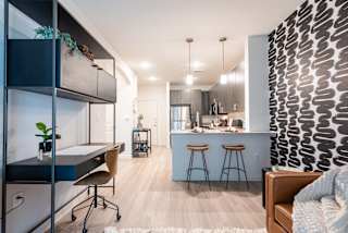 a home office with a desk and stools next to a kitchen with a breakfast bar at Avery Ranch, Texas, 78717
