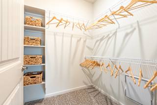 a walk in closet with white walls and a white closet door with gold hangers at Avery Ranch, Texas, 78717