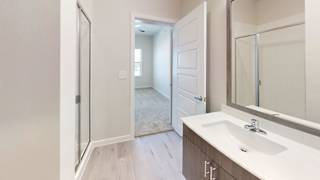 an empty bathroom with a mirror and a sink at Bridge at Speyside Apartments, Austin, Texas