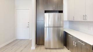 a stainless steel refrigerator in a kitchen with white cabinets at Bridge at Speyside Apartments, Austin, 78754