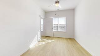 A room with a ceiling fan and a window with blinds. at Park South Apartments, Austin, Texas