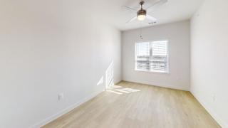 A room with a ceiling fan and a window with blinds. at Park South Apartments, Austin, 78748
