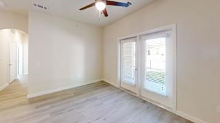 A room with a ceiling fan and a window with blinds. at Bridge at Speyside Apartments, Texas