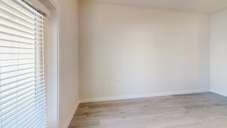 A room with wooden flooring and white walls. at Bridge at Speyside Apartments, Austin, 78754