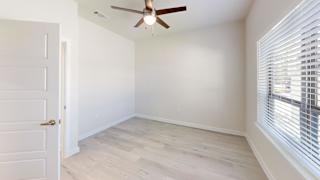 A room with a ceiling fan and a door. at Bridge at Speyside Apartments, Texas, 78754