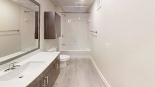 A white sink with a mirror above it in a bathroom. at Bridge at Speyside Apartments, Austin, Texas