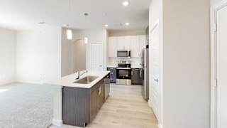 A kitchen with a sink and a refrigerator. at Bridge at Speyside Apartments, Austin, Texas