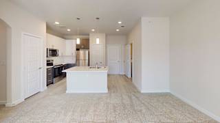 A kitchen with white cabinets and a white island in the middle. at Bridge at Speyside Apartments, Texas, 78754