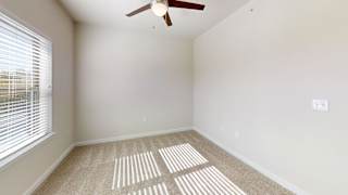A room with a ceiling fan and a window with blinds. at Bridge at Speyside Apartments, Texas