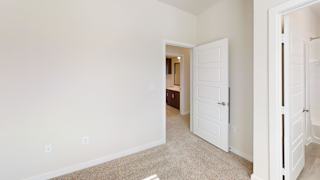 A white door is open to a hallway. at Bridge at Speyside Apartments, Austin, 78754