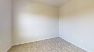 A room with a carpeted floor and white walls at Bridge at Speyside Apartments, Texas, 78754