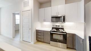 A modern kitchen with a stainless steel oven and microwave.