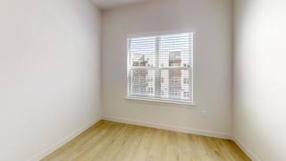 A room with a window and wooden flooring. at Park South Apartments, Austin, Texas
