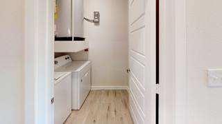 A white kitchen with a dishwasher and a washing machine. at Bridge at Speyside Apartments, Austin, TX, 78754