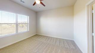 A room with a ceiling fan and a window with blinds. at Bridge at Speyside Apartments, Austin, TX, 78754