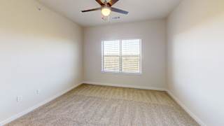A room with a ceiling fan and a window with blinds. at Bridge at Speyside Apartments, Texas, 78754
